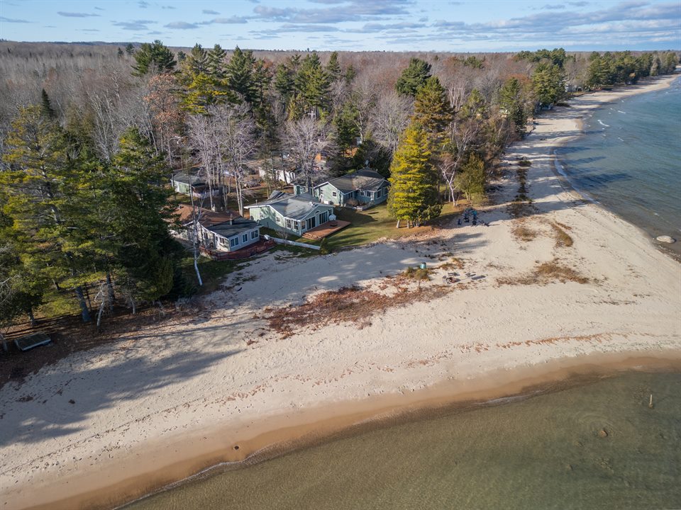 Lakefront property and winding shoreline photographed from above